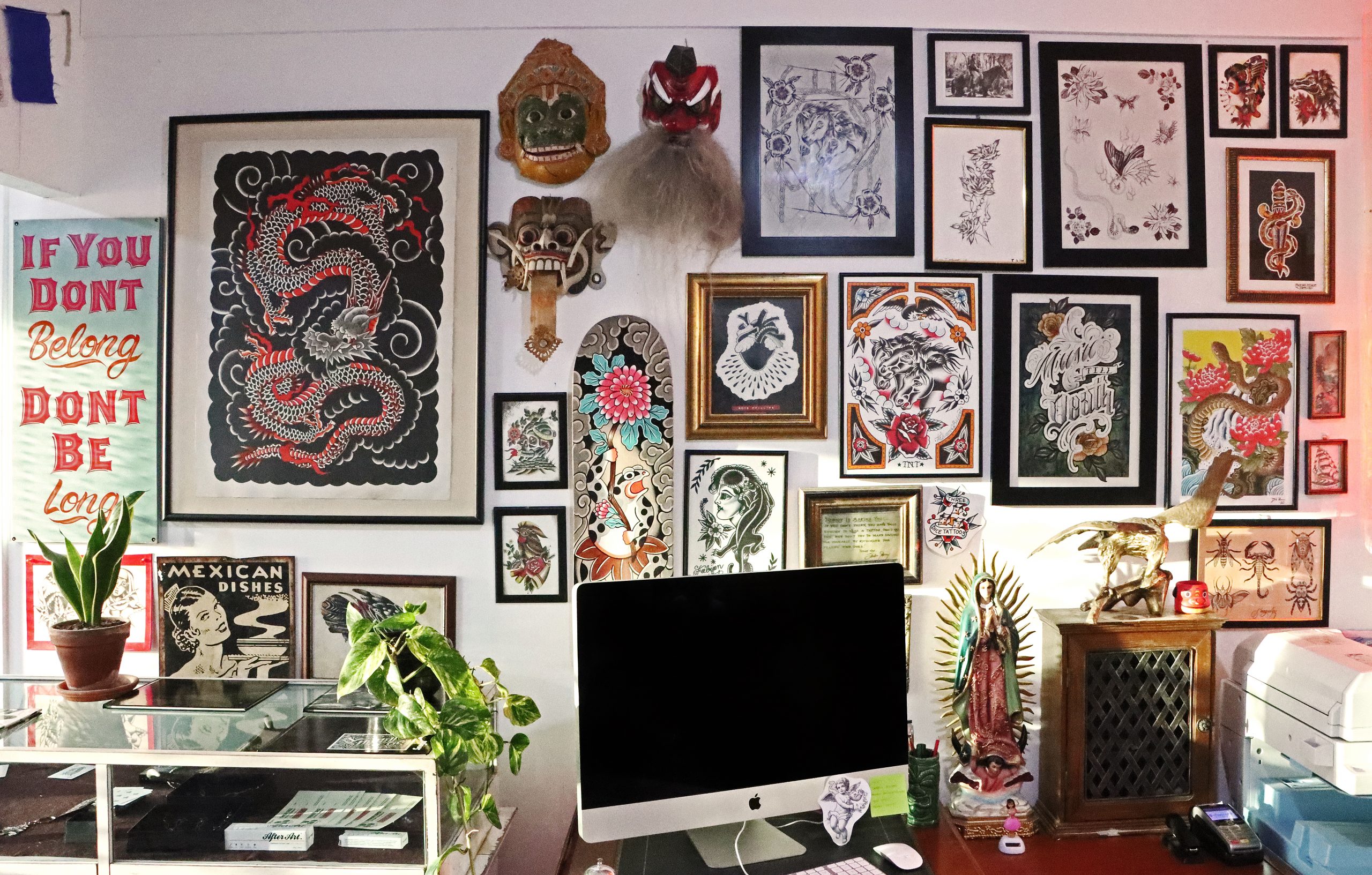 A view of the front desk at Three Dice Tattoo, a tattoo studio based in Auckland, New Zealand, showcasing classic, modern, Japanese and custom designs.